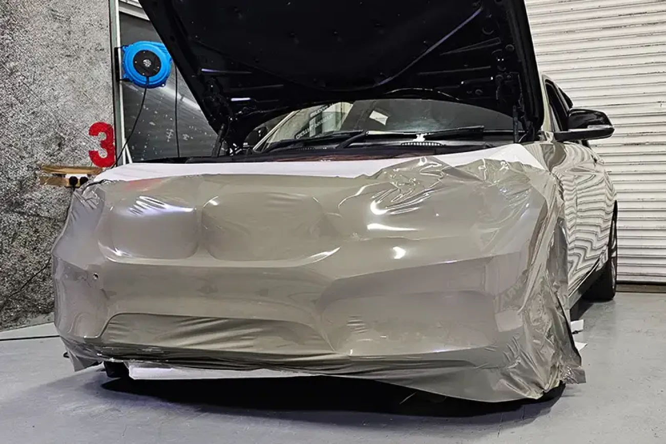 BMW 1 Series during full colour change wrap preparation in khaki green vinyl